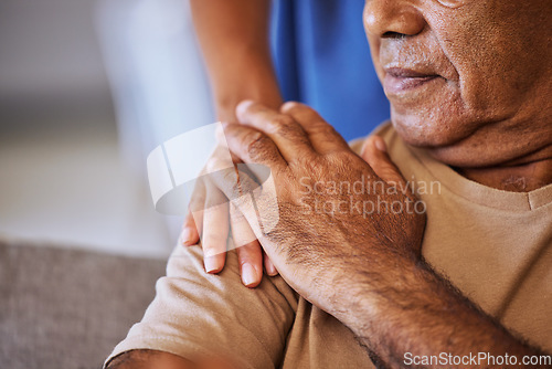 Image of Support, care and helping hands for an elderly patient during a consultation at a nursing clinic. Closeup of hope, trust and comfort from a woman caregiver consulting a senior man in retirement home