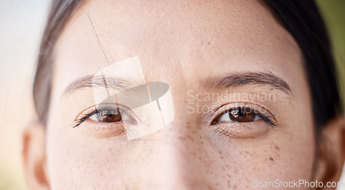 Image of Woman, freckles and portrait of natural eyes closeup with thinking and idea facial expression. Young girl with bare face, beauty and healthy skin spots and brown iris for skincare campaign.
