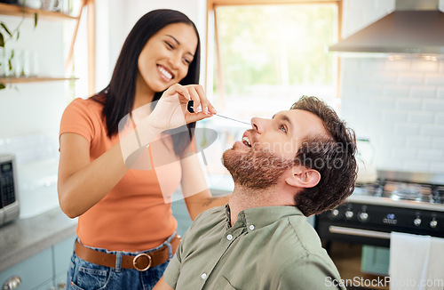 Image of Covid, sick and couple doing pcr test in home kitchen for healthcare compliance, wellness and safety together with easy check. Care, love and support people with corona virus nose inspection