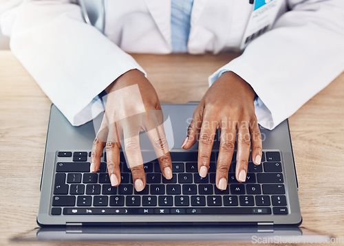 Image of Hands, woman and doctor with laptop working at a desk in a hospital office. Medical expert with wireless technology to diagnose or research diseases in the field of health and medicine online or web