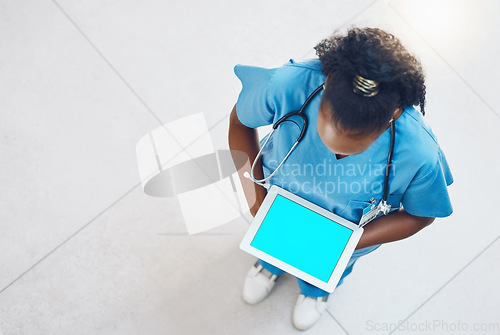 Image of Tablet, green screen and doctor or nurse for hospital app advertising, online software marketing or telehealth clinic management. Black woman healthcare worker on digital IT technology mock up above