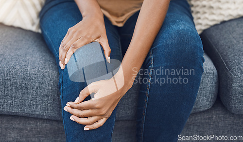 Image of Black woman, hands and knee injury pain for person on house living room sofa or home interior lounge. Zoom on healthcare, wellness or medical surgery burnout, stress and legs muscle accident on couch