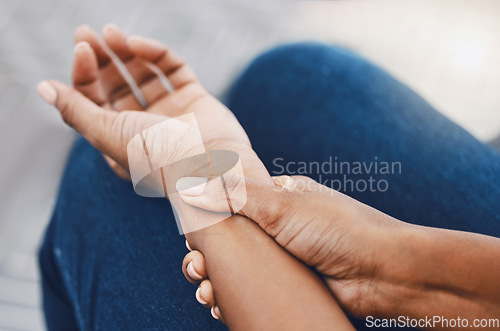 Image of Hands, arm injury or pain of black woman after working hard in home or house interior. Hand, health and wellness of African female injured wrist after work on pc computer, carpal tunnel or arthritis.