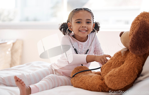 Image of Children, stethoscope and teddy bear with a girl playing doctor in her bedroom at home with a stuffed animal. Imagination, healthcare and medicine with a cute female child being a pretend nurse