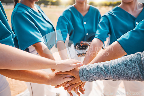 Image of Hand, sports and teamwork with a sport team putting their hands in a huddle while standing in a circle outdoor on a field. Collaboration, goal and motivation with a group of women training for a game