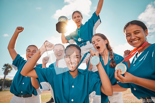 Image of Women, winner and baseball team winning a trophy award medals after a successful match game together. Smile, teamwork and happy girls on field in celebration of a reward prize in a sports tournament