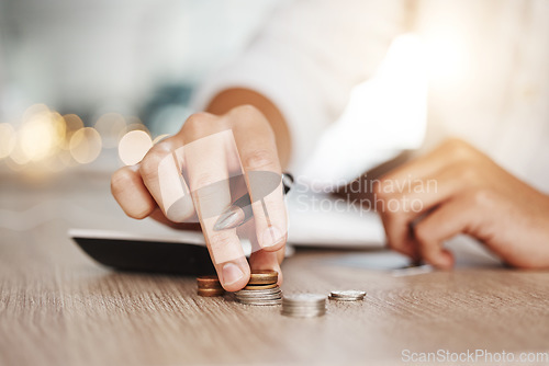 Image of Business man hands with coins budget money for inflation, debt or finance management working with calculator on wooden table and lens flare. Entrepreneur or startup person with profit cash or savings