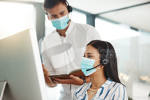 Image of Covid, face mask and call center woman training intern on customer service computer, contact us and crm consulting office. Virus compliance, receptionist teamwork or learning consultant collaboration