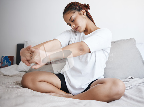 Image of Wake up, yoga and woman stretching on her bed in the morning for fitness, exercise or meditation. Mindset, lifestyle and workout of a healthy, spiritual and relax black woman in her home bedroom