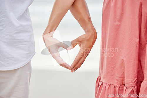 Image of Couple hands, heart and love at beach outdoors for love, care and kindness emoji together. Closeup of happy people save the date relationship, finger shape and affectionate romance of trust marriage