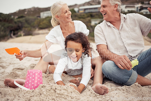 Image of Family, beach and a girl and her grandparents playing in the sand outside during summer. Kids, love and vacation with a man and woman and granddaughter laughing and bonding outdoor