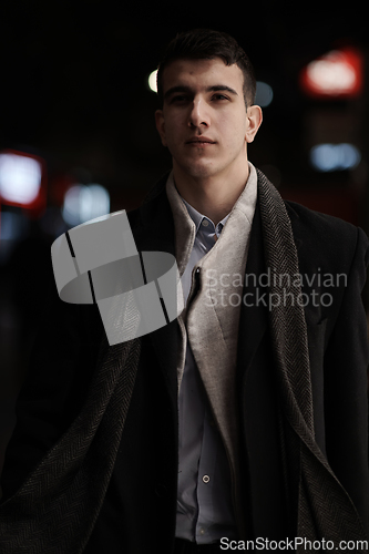 Image of Smiling Meedle Eastern man walking down street near modern office building,