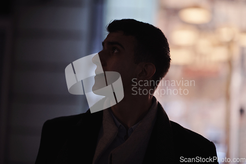 Image of Smiling Meedle Eastern man walking down street near modern office building,