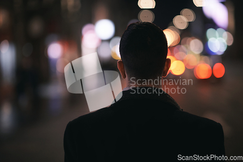 Image of Smiling Meedle Eastern man walking down street near modern office building,