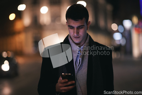 Image of Smiling Meedle Eastern man walking down street near modern office building,