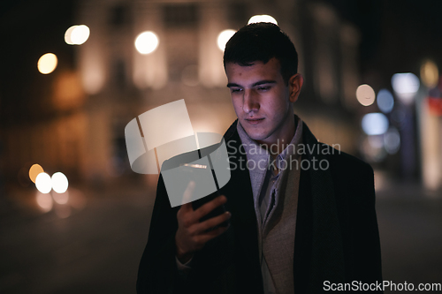 Image of Smiling Meedle Eastern man walking down street near modern office building,