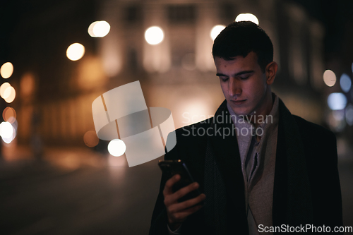 Image of Smiling Meedle Eastern man walking down street near modern office building,