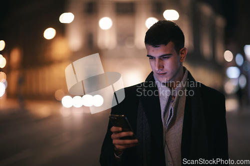 Image of Smiling Meedle Eastern man walking down street near modern office building,