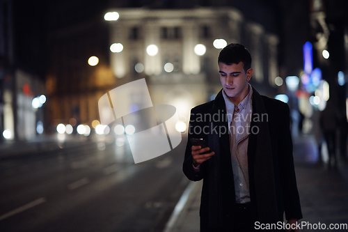 Image of Smiling Meedle Eastern man walking down street near modern office building,