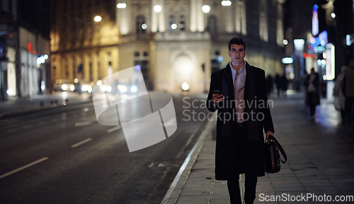 Image of Smiling Meedle Eastern man walking down street near modern office building,