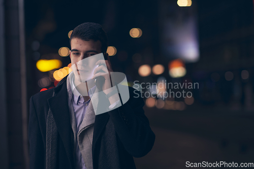 Image of Smiling Meedle Eastern man walking down street near modern office building,