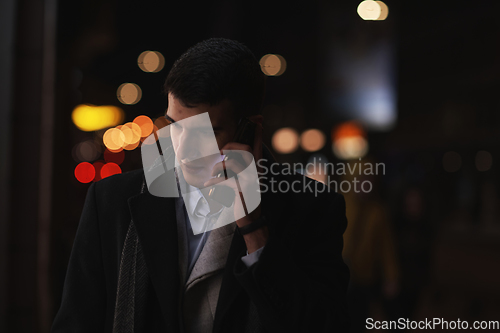 Image of Smiling Meedle Eastern man walking down street near modern office building,