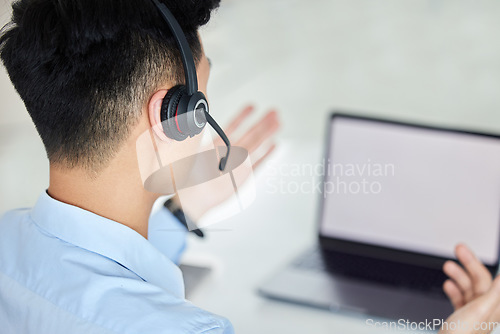 Image of Call center, customer service and telemarketing with a man working on a laptop with a headset in his office. Crm, contact us and consulting with a male consultant at work in sales or support