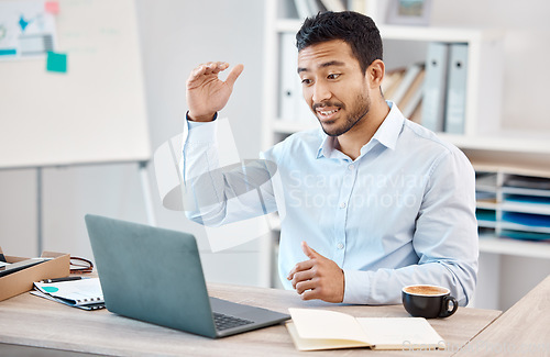 Image of Man with laptop at desk on video call for work, via web in office with coffee and gesture with hand. Young man at table in home office, with computer on the internet for business call or webinar.