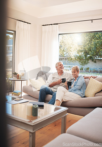 Image of Senior couple with coffee or tea and relax on sofa in their living room happy with retirement, real estate and lifestyle. Elderly people drink on couch or in lounge together while talking of marriage