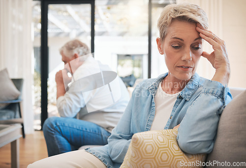 Image of Mature couple, stress or divorce fight in house living room or home interior sofa. Angry, sad or depression woman face with anxiety in cheating affair argument with man in marriage therapy counseling