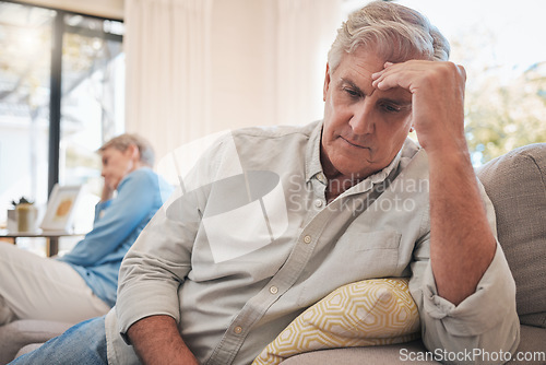 Image of Divorce, fight and problem with senior couple on sofa for conflict, cancer or depression together. Mental health, frustrated and angry with man and woman in retirement with fear, sad and marriage