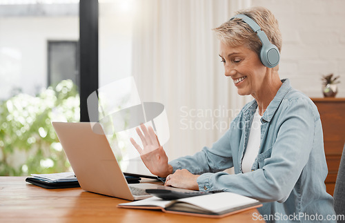 Image of Laptop webinar, woman or video conference training and meeting on online call in home office or house room interior. Smile, happy and mature remote worker with headphones waving on tech interview