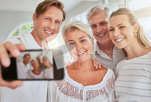 Image of Selfie, family and phone with a mobile in the hand of a man with his senior parents in a home for a visit. Happy, smile and love with elderly pensioner parents and their adult children taking a photo