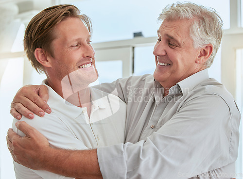 Image of Family, love and man with a son hugging his senior father during a visit in their home together. Happy, smile and relationship with an elderly male pensioner and his adult child embracing in a house