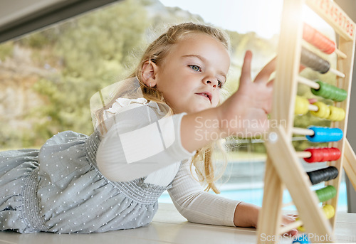 Image of Education, learning and girl counting and practice math in homeschool activity. Child development, abacus and distance learning with child playing and relaxing in a living room, being playful alone