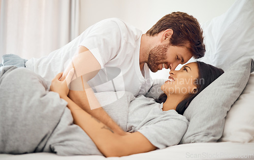 Image of Love, morning and wake up with couple in bed together for care, communication and happy. Sleeping, relax and smile with young man and woman lying in bedroom for support, marriage and happiness