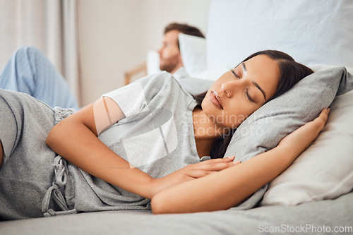 Image of Sleeping, peace and woman asleep on bed with comfortable pillow while taking nap to relax with sleepless partner in background. Couple, sexual problems and carefree wife lying eyes closed next to man