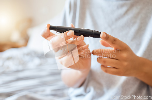 Image of Healthcare, diabetes, and a woman using blood sugar test on finger in bedroom alone. Health, innovation and the daily life of a diabetic lady on bed with glucometer to check glucose level at home.