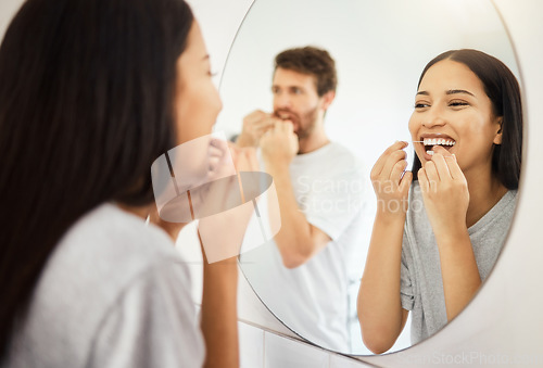 Image of Mirror, dental floss and teeth healthcare couple cleaning mouth for healthy gums, smile and fresh breath. Man and woman in bathroom flossing morning during routine for dental hygiene in the morning