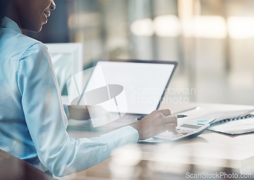 Image of Finance, budget and accounting on a laptop with mockup screen and calculator with planning financial or advisor in a office. Accountant, savings and business cost writing notes, planning and tax