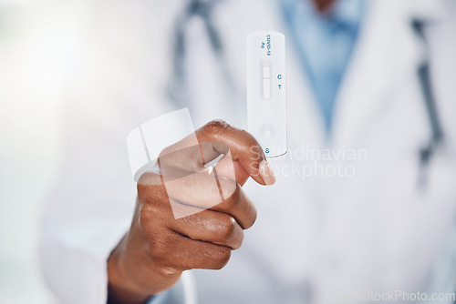 Image of Doctor hands, covid and negative rapid antigen test results in hospital for healthcare, medical risk and safety. Closeup corona virus surgeon, medicine worker and clinic expert holding pcr cassette