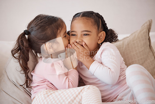 Image of Girl, friends or children whisper secret to best friend on home sofa while relax together on play date. Communication, conversation and sisters or youth kids gossip at fun slumber party or sleepover