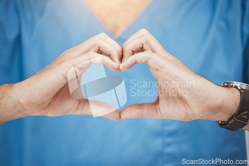 Image of Doctor or nurse make heart sign, with hands to show care or compassion. Woman worker in healthcare show love icon with fingers, as expression of love for their job or wellness of patients