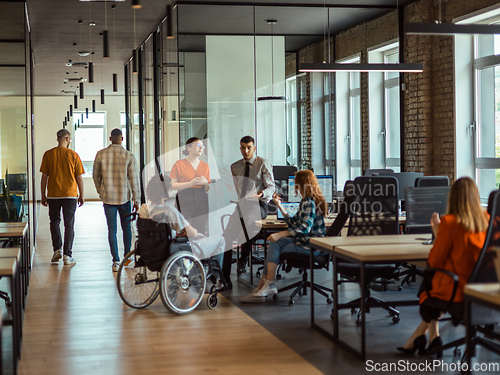 Image of A diverse group of young business individuals congregates in a modern startup coworking center, embodying collaborative innovation and a dynamic atmosphere