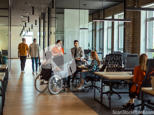 Image of A diverse group of young business individuals congregates in a modern startup coworking center, embodying collaborative innovation and a dynamic atmosphere