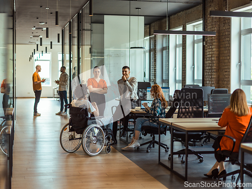 Image of A diverse group of young business individuals congregates in a modern startup coworking center, embodying collaborative innovation and a dynamic atmosphere