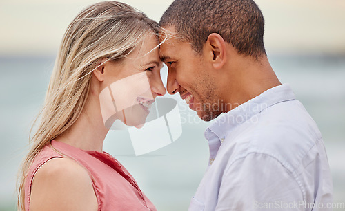 Image of Portrait of couple at the beach with their forehead touching. Multiracial man and woman in relationship, happy, smiling and in love on vacation. Bonding, love and quality time together