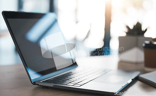 Image of Laptop on a desk in modern office to work on a project, virtual business meeting or online research. Closeup of a computer, technology and pc on a table in the minimal company building.