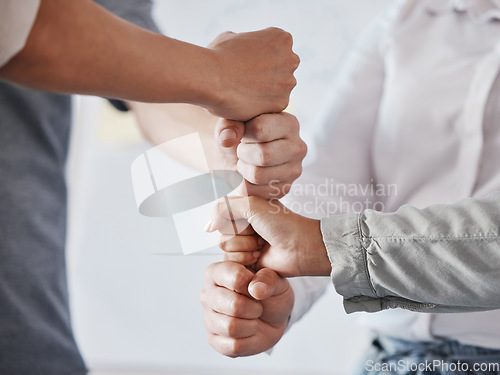 Image of Hand, teamwork and collaboration with the hands of business people working as a team or group in the office. Trust, solidarity and synergy with workforce staff standing in a huddle together at work