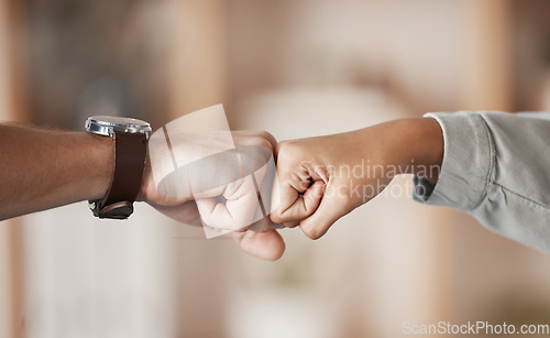 Image of Hands, teamwork and fist bump with a business man and woman fist bumping together in their office. Winner, goal and collaboration with a male and female employee celebrating a goal or target at work